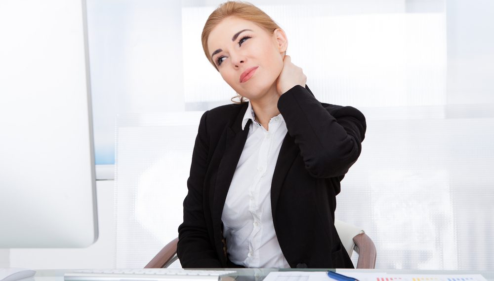 Portrait Of Young Businesswoman Suffering From Neck Pain