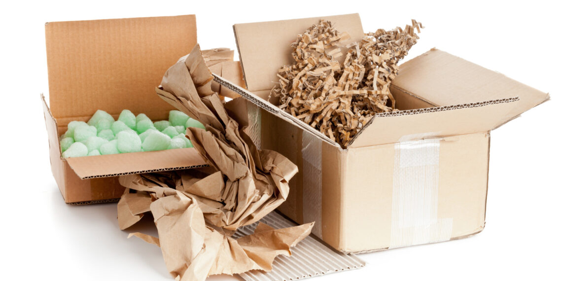  Various types of packaging materials including cardboard boxes, bubble wrap, and packing peanuts are shown.
