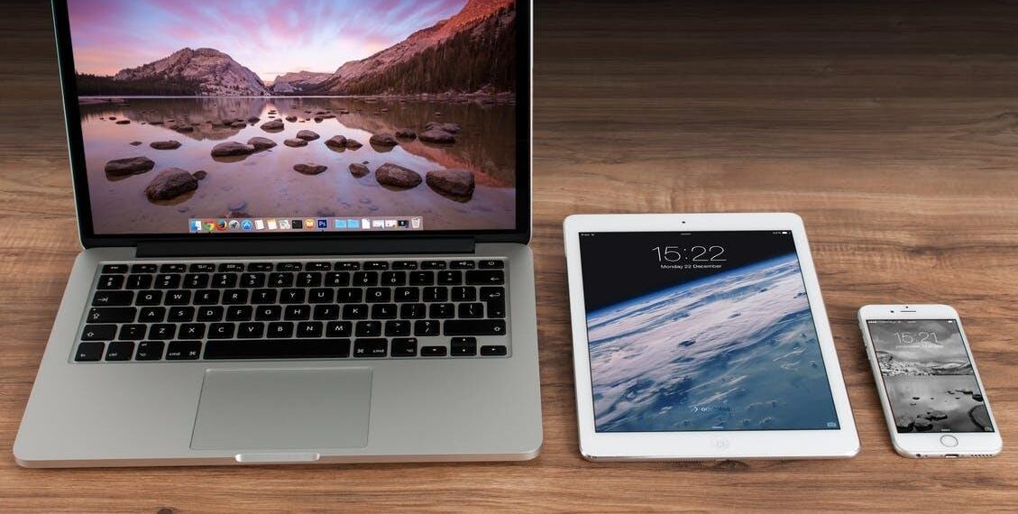 Macbook Pro Beside White Ipad