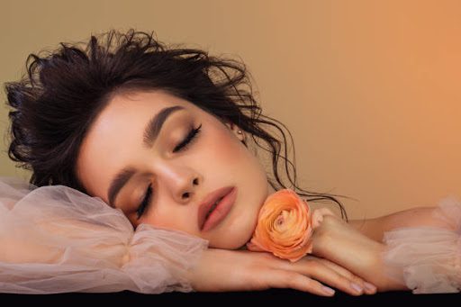 Beautiful woman with flower and perfect make-up