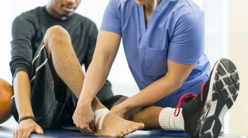 An athlete receiving rehibilitative care for a sports injury.