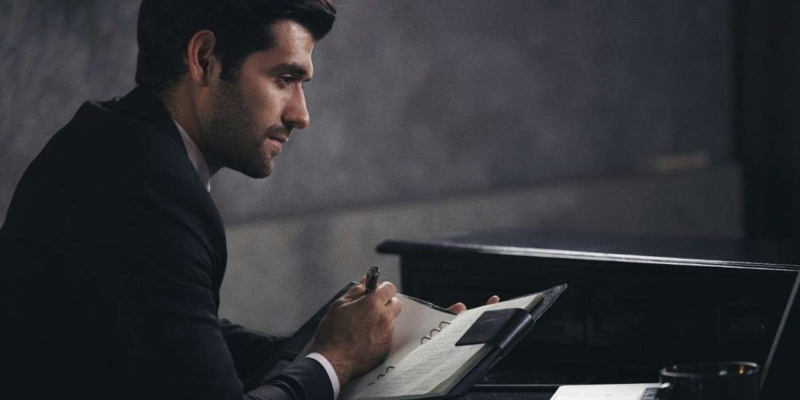 man-writing-on paper