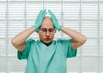 Healthcare professionals discussing wellness strategies in a bright, collaborative hospital meeting room