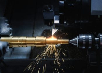 CNC machining equipment producing precision metal components alongside THC testing kit materials in a manufacturing facility